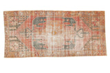 Distressed vintage Oushak runner with sharp geometric medallion and floral border in faded red, navy, ivory, 4'x8'8