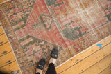 Textured cherry red and charcoal Oushak rug with serrated geometric medallion and original selvage.