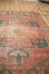 Distressed vintage Oushak rug texture, revealing geometric patterns and exposed foundation.