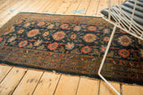 Detail of Antique Fine Lilihan rug: indigo field, vibrant medallions, arabesques, worn edge.