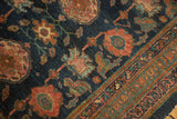 Antique Fine Lilihan rug corner detail: indigo field, faded raspberry arabesque, intricate geometric border.