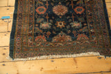 Bottom edge of the antique Lilihan runner, displaying worn white fringe, intricate borders, and vibrant floral motifs.