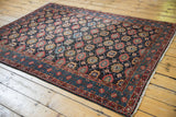Vintage Malayer collector rug from an angle, showing its vibrant allover Veramin pattern.