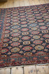 Angled view revealing the low, even pile and intricate Veramin motif of a vintage Malayer rug.