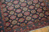 Tattered but secured fringe on a vintage Persian Malayer with complex geometric borders.