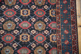Evenly worn pile on a vintage Malayer rug, detailing the brilliant indigo, red, and blue veramin motif.