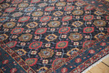 Even wear across the knot heads of a fine Malayer rug's indigo and red veramin pattern.