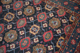 Alternating color fills and asymmetric contours in the Veramin motif of a fine Persian Malayer.