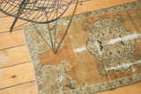 Faded burnt orange field, scalloped floral medallion, and scrolling buds on a distressed Oushak.