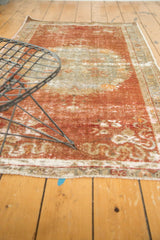 Distressed vintage Oushak rug pile with worn knot heads and faded rococo floral design.