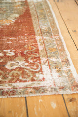 Distressed vintage Oushak runner's textured edge, revealing low pile and color migration.