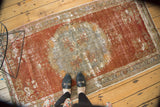 Decorative distressed texture of a vintage Oushak runner, showing color migration.