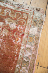 Distressed Oushak runner's textured corner with visible foundation, rich cinnabar, and ivory tones.