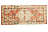 Distressed hand-knotted Turkish Oushak runner, hexagonal medallion, cherry red, and ivory tones.