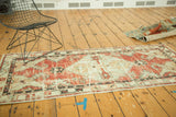 Worn cherry red and ivory distressed Oushak runner, highlighting its dramatic serrated geometric contours.