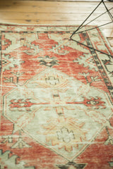 Distressed vintage Oushak runner texture, showing serrated contours, faded red, ivory, and hard fold wear.