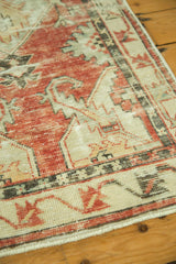 Distressed cherry red and ivory Oushak runner with serrated geometric patterns.