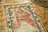 Distressed Oushak rug runner's hexagonal medallion with faded red, ivory, and visible texture.