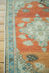 Vintage Distressed Oushak rug detail with dramatic abrash, burnt orange field, and sky blue border.