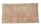 Distressed vintage Oushak rug, concentric medallion, dusty rose, ivory, and oxidized silver tones.