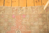 Distressed hand-knotted Oushak rug pile with fluorescent pink pops.