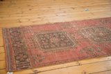 Distressed Oushak runner gul medallion and Kufic border in raspberry, blue, charcoal.
