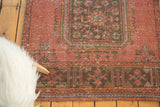 Distressed vintage Oushak runner detail, raspberry red field, charcoal and pale blue motifs.