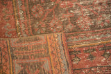 Distressed hand-knotted Oushak runner pile, secured edge, in raspberry, blue, and brown tones.