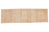 Distressed vintage Oushak runner with pale terra cotta, muted blue-black, faded medallion pattern.