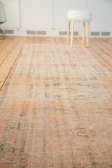 Distressed vintage Oushak runner texture with even wear, featuring soft terra cotta and green.