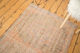 Textured distressed Oushak rug runner showing worn pile, muted terra cotta, and seafoam green.