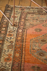 Malayer rug border with stylized floral and stepped geometric patterns in apricot, ivory, and charcoal.