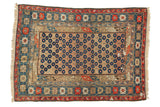 Early 20th century Caucasian rug, allover navy blossomed motif, camel field, with brick red and teal borders.