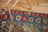 Antique Caucasian rug section, brick red, ivory, and navy geometric blossom pattern.