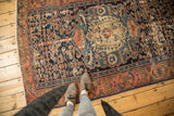 Antique Malayer rug with ornate medallion, Herati motif, indigo and madder red, showing foundation wear.