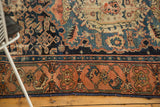 Densely woven madder red border and indigo Herati pattern on an antique Malayer rug.
