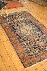 Antique Malayer rug, ornate medallion, intricate Herati field, deep indigo, madder red borders, showing wear.