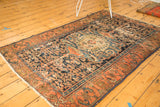 Antique Malayer rug, rococo-influenced medallion, intricate Herati field, with visible wear.