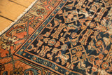 Close-up of antique Malayer rug with intricate border and dense Herati pattern.