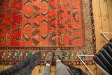 Antique Hamadan rug: heavily abrashed blush field with unusual floating blue and orange Mahi motifs.