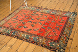 Antique Hamadan rug corner: tattered edges, geometric border, and abrashed Herati Mahi motifs.