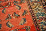 Antique Hamadan rug with abrashed blush field, blue and teal Herati Mahi motifs, and geometric border.