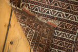 Belouch Bag Face rug corner, showing geometric patterns, tattered fringe, and reverse weave.