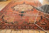 Antique Farahan Sarouk corner with intricate vinery, scalloped border, blush, navy, green, and wear.