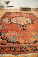 Antique Farahan Sarouk carpet's lower border featuring navy floral vinery and tattered fringe.