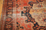 Worn antique Farahan Sarouk carpet detail with blush, navy, and sand floral vinery.