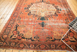 Antique Farahan Sarouk rug border with worn navy vinery and blush field wear.