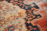 Threadbare texture and delicate floral vinery in sand, navy, and blush on an antique Persian Sarouk.