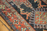 Karaja rug detail: red lion arabesques and geometric patterns on navy, red, and blue.