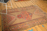 Tattered edge, rectilinear floral patterns, and mini botehs on an antique Caucasian rug corner.